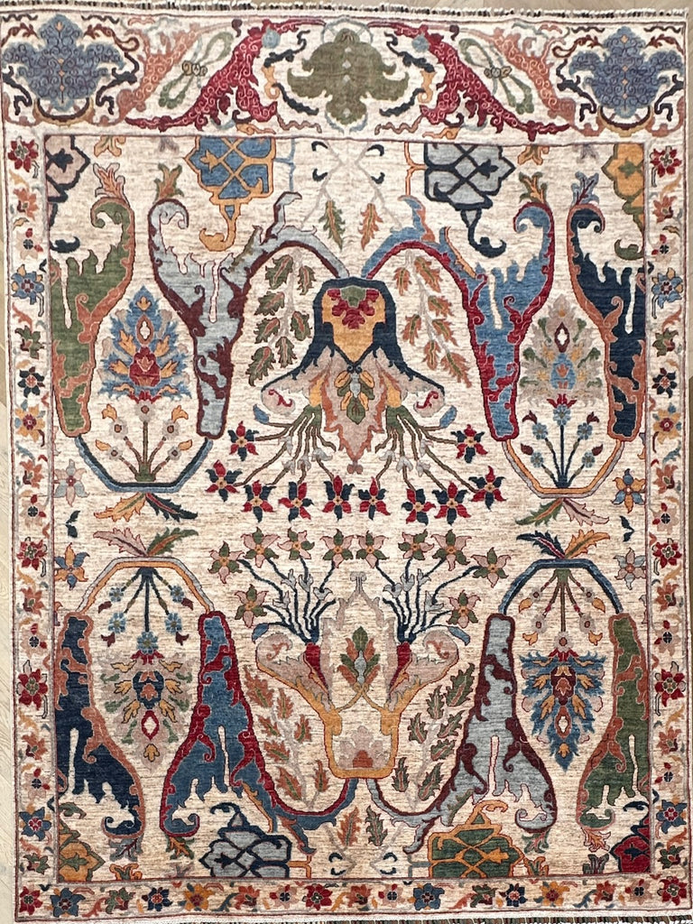 Full view of Afghan handmade floral rug with cream field, blue, olive, terracotta and burgundy motifs