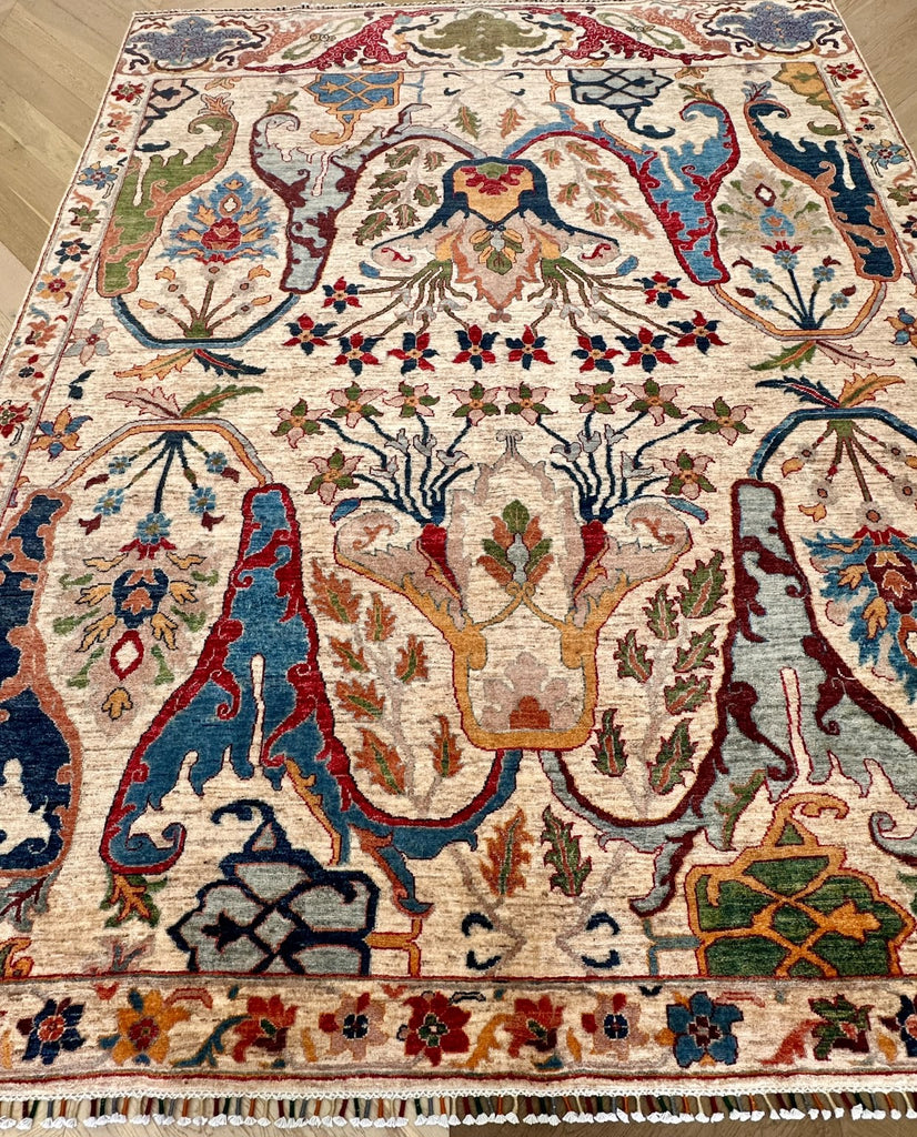 Angled view showing floral pattern, natural pile variation and multicoloured fringe
