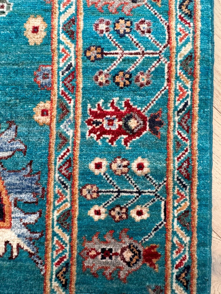 Detailed floral border of naturally dyed Afghan Sultani Chobi rug
