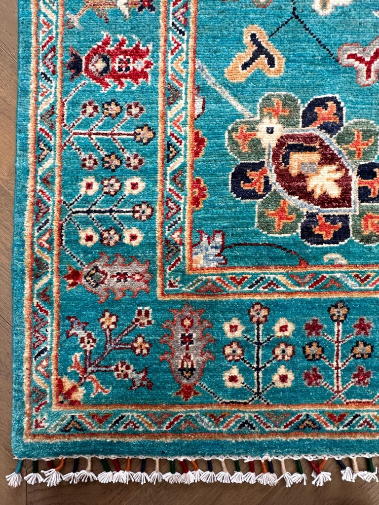Hand-knotted border and fringe detail of Afghan Sultani Chobi wool rug