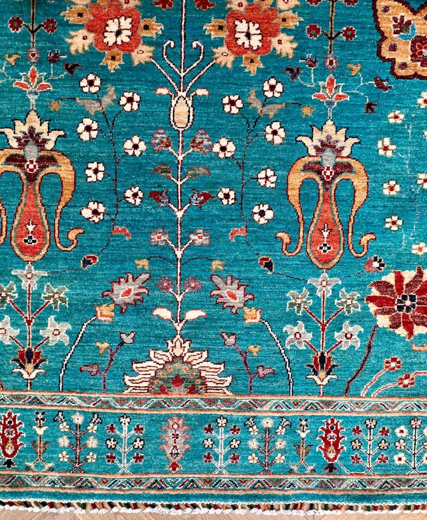 Close detail of Afghan Sultani Chobi rug floral design and natural colour variations