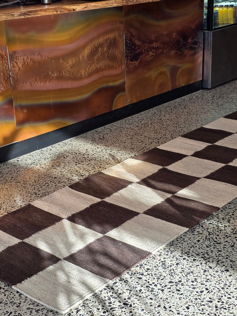 Checkered wool hallway runner in a cafe interior