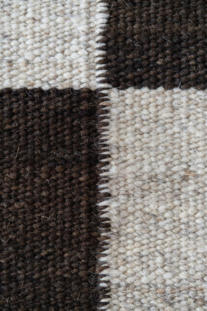 Detailed view of dark and ivory wool checks
