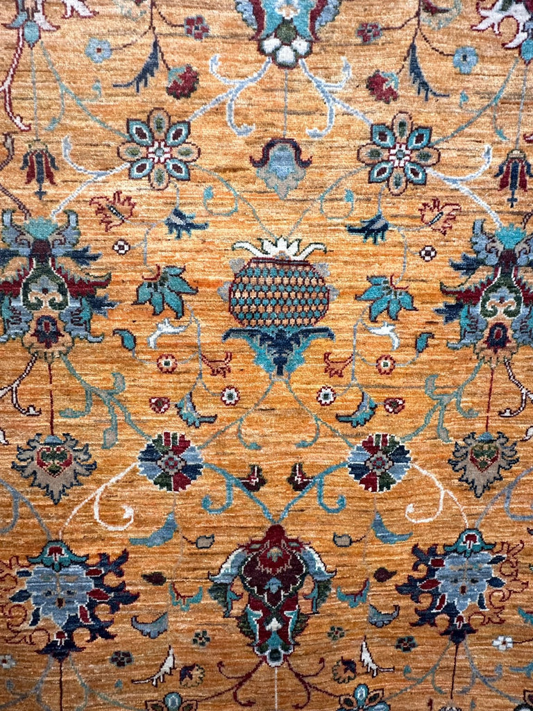 Detail of lattice floral motif and natural horizontal colour variation in the golden Chobi rug